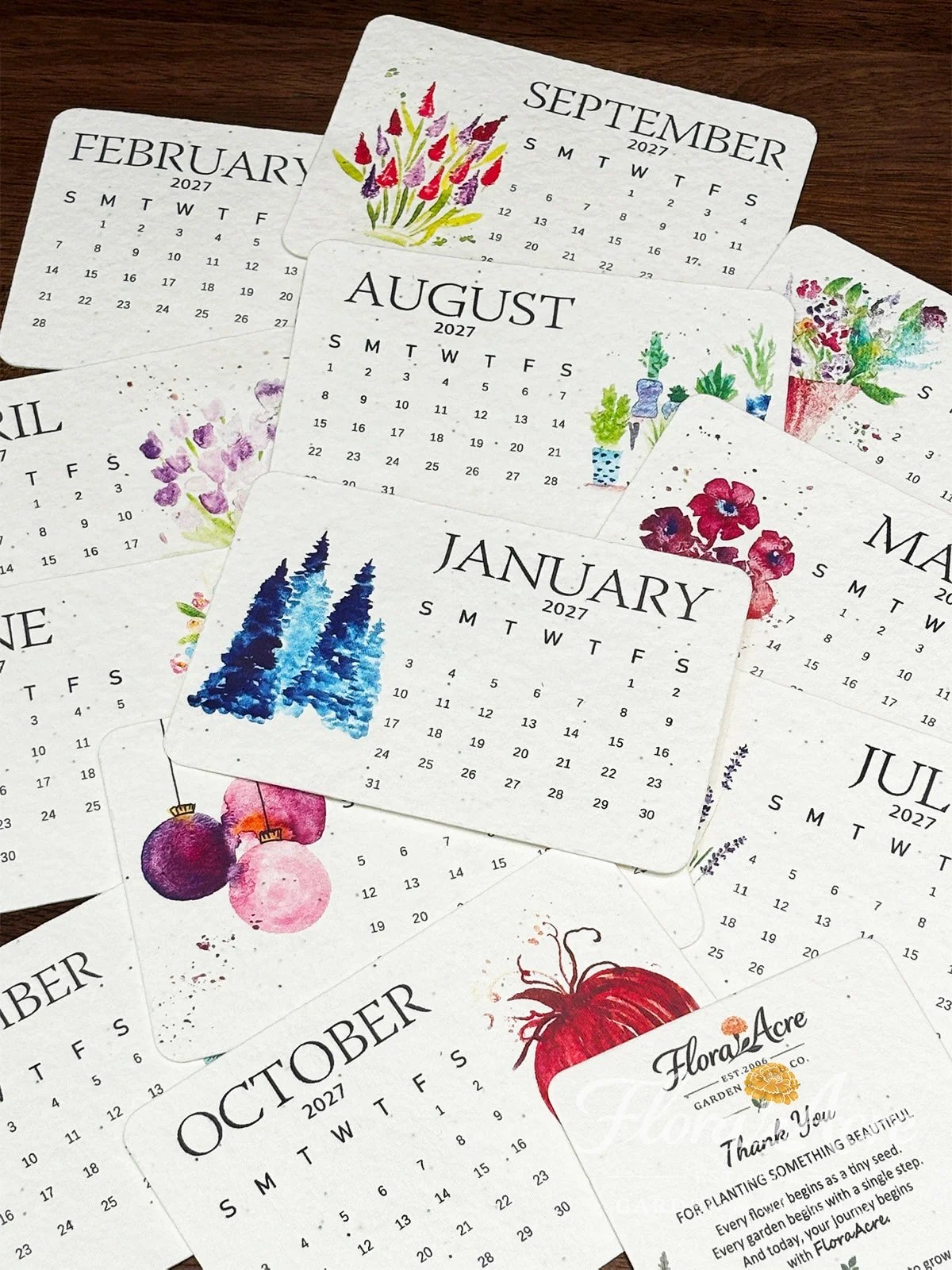 Close view of watercolor 2027 seed paper calendar cards