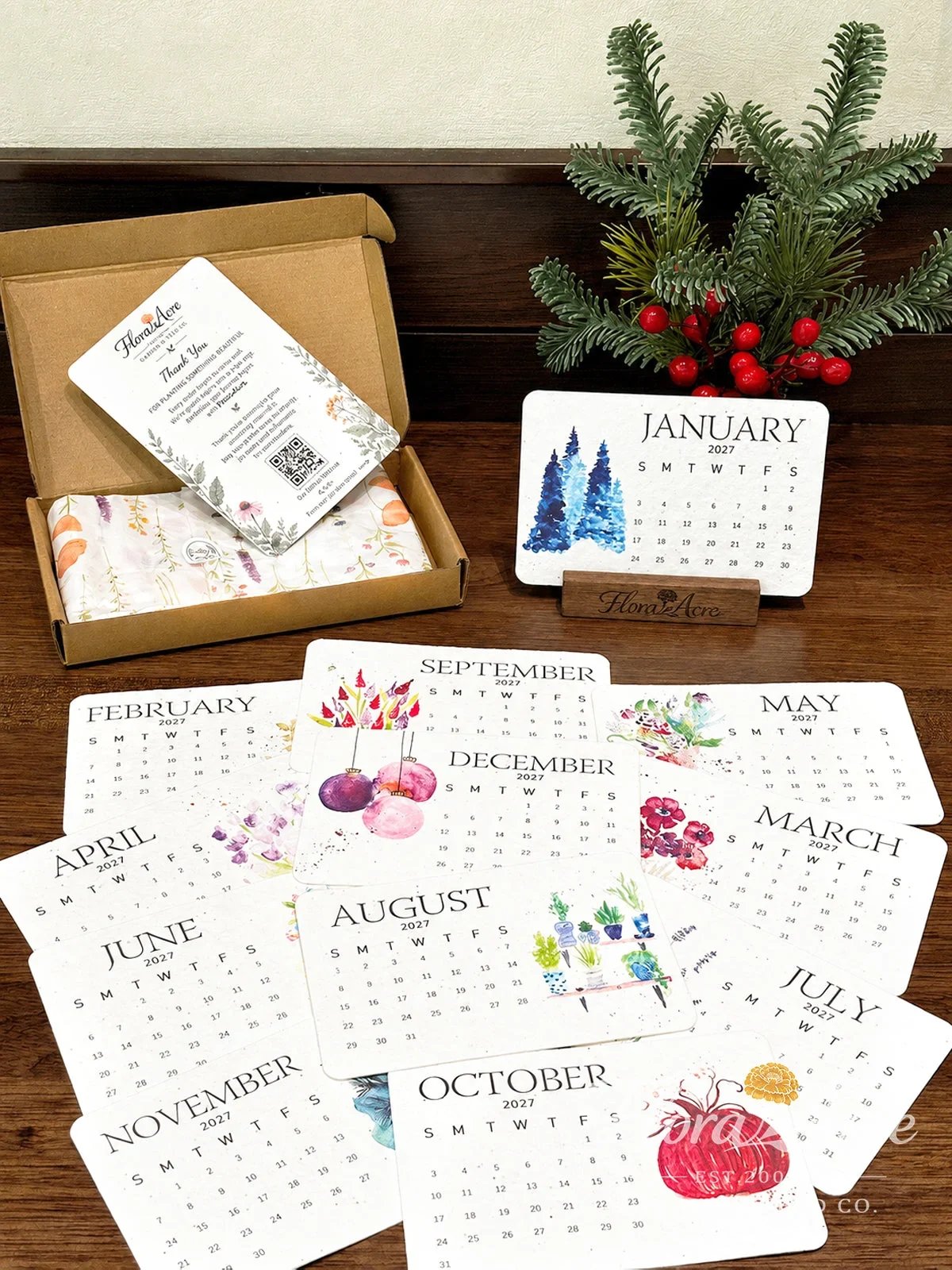 Complete 2027 seed paper calendar collection arranged beside gift box